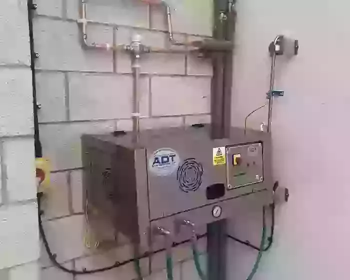 Electric wall-mounted three-phase pressure washer installed with copper inlet pipework at a manufacturing facility in Nottingham.